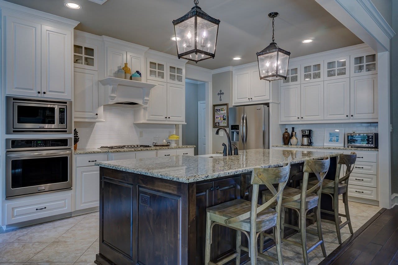 Kitchen · granite island under lantern pendants