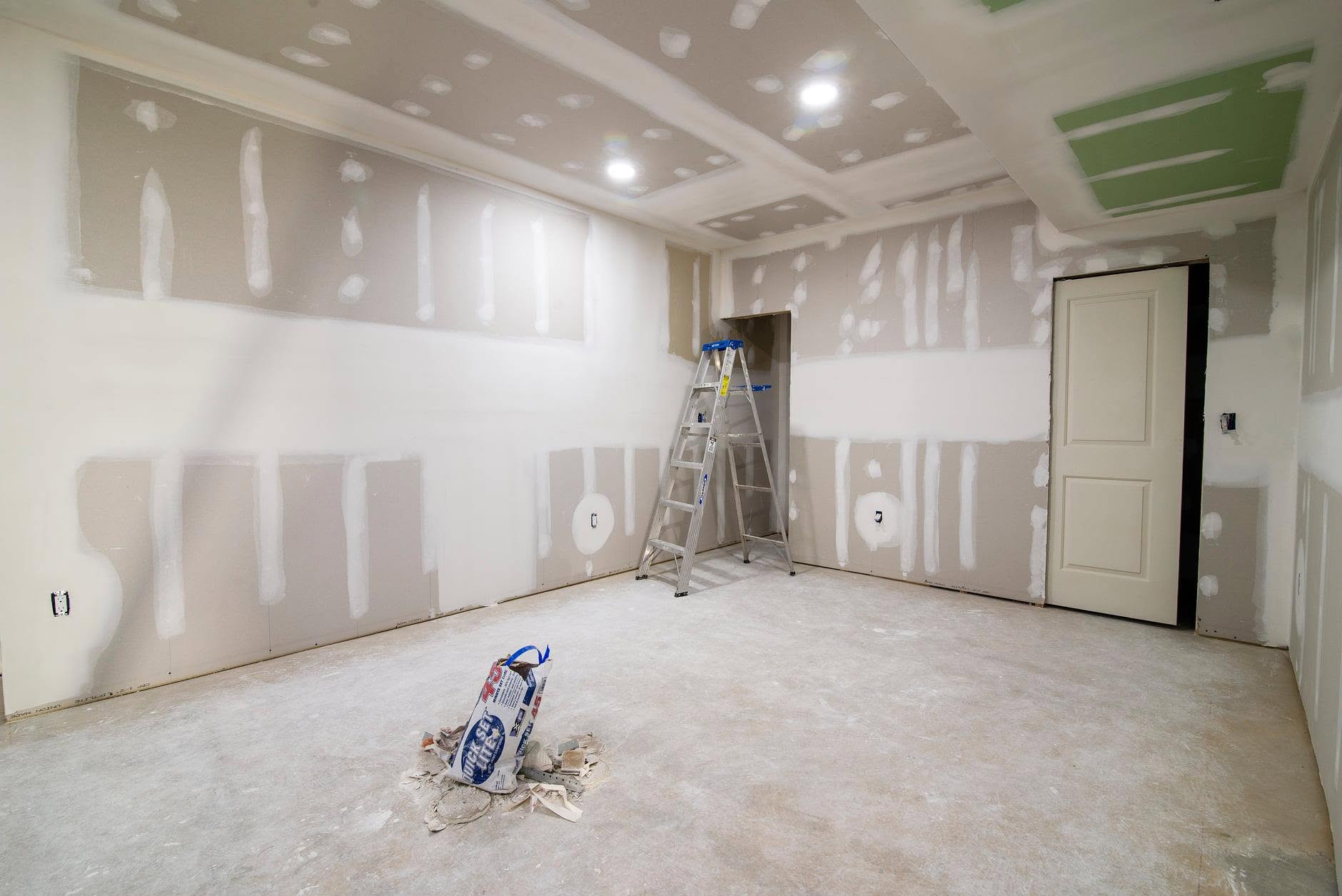 Before: room with new drywall hung, ready for finishing