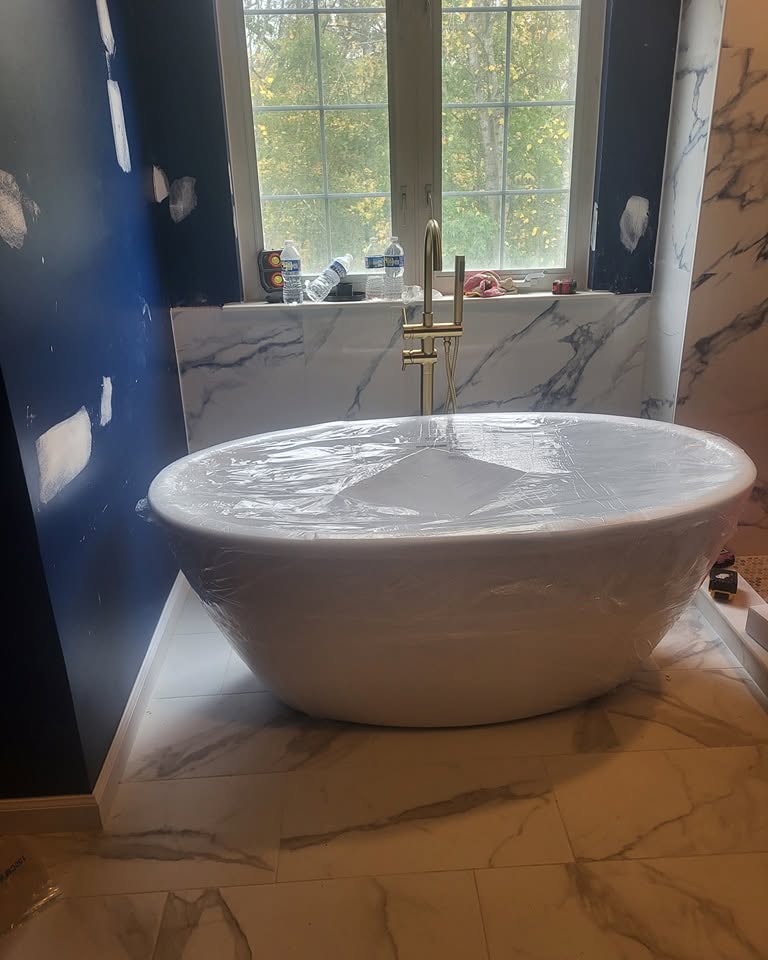 Bathroom · freestanding tub with a brass filler