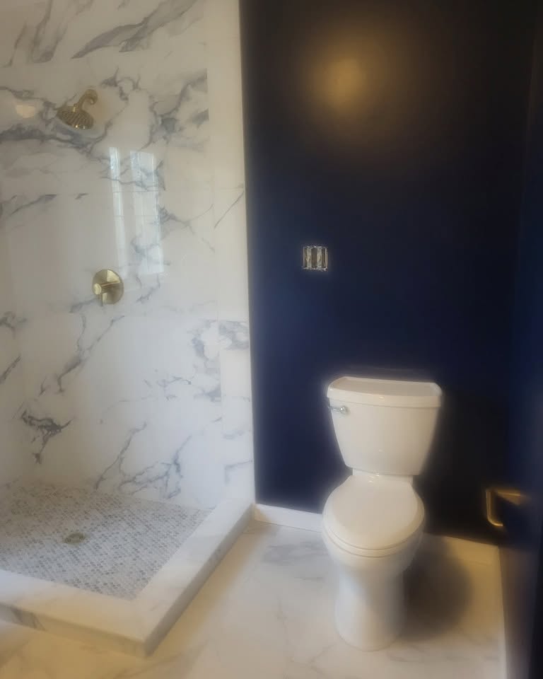 Shower · marble-look tile with a tiled floor