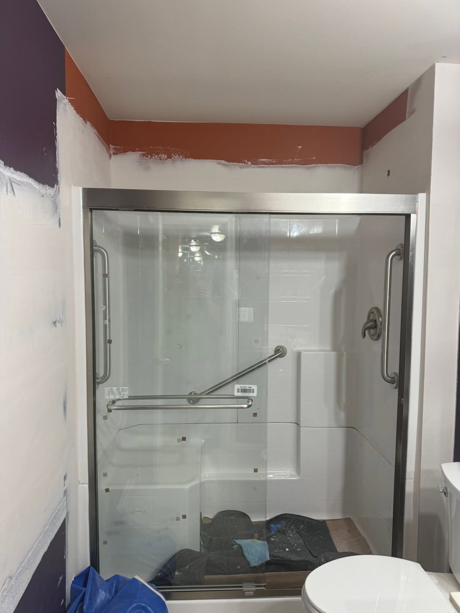 After: the same bathroom with a new shower and sliding glass enclosure