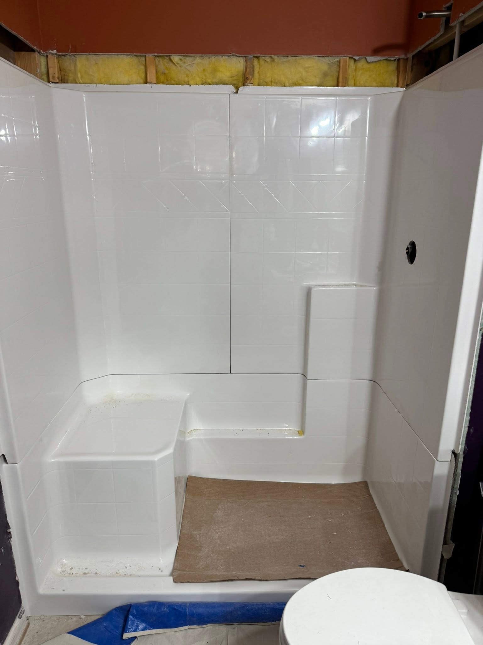 After: new one-piece shower surround with a built-in seat