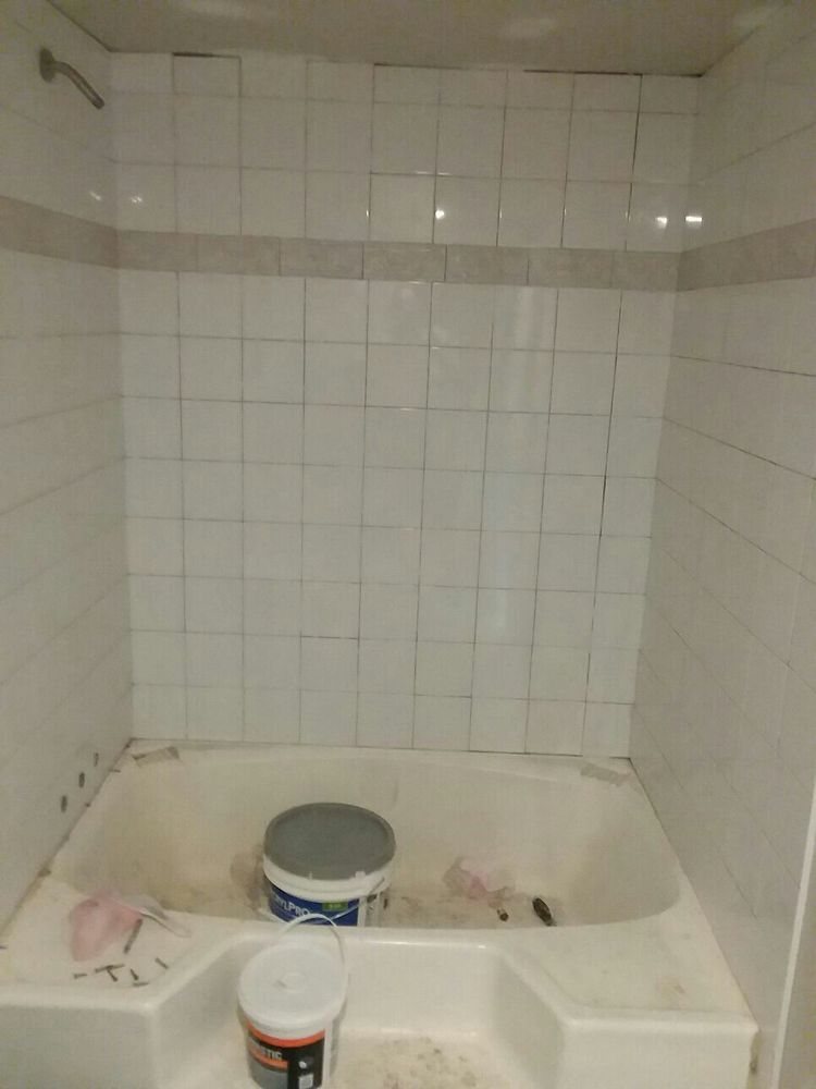 After: the same tub surround finished in white tile